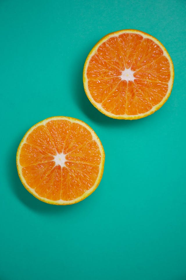 Photo by Lucas George Wendt: https://www.pexels.com/photo/sliced-orange-fruit-on-teal-background-4695354/